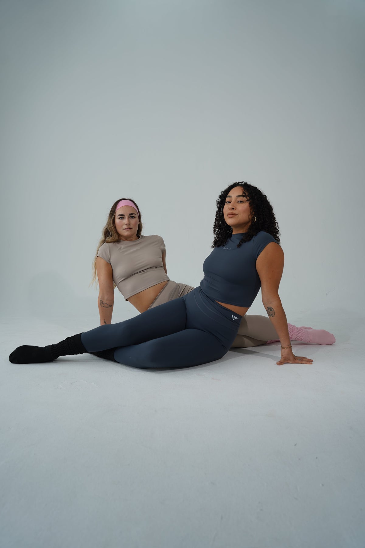 A woman foam rolling and stretching to prioritize recovery for women athletes.
