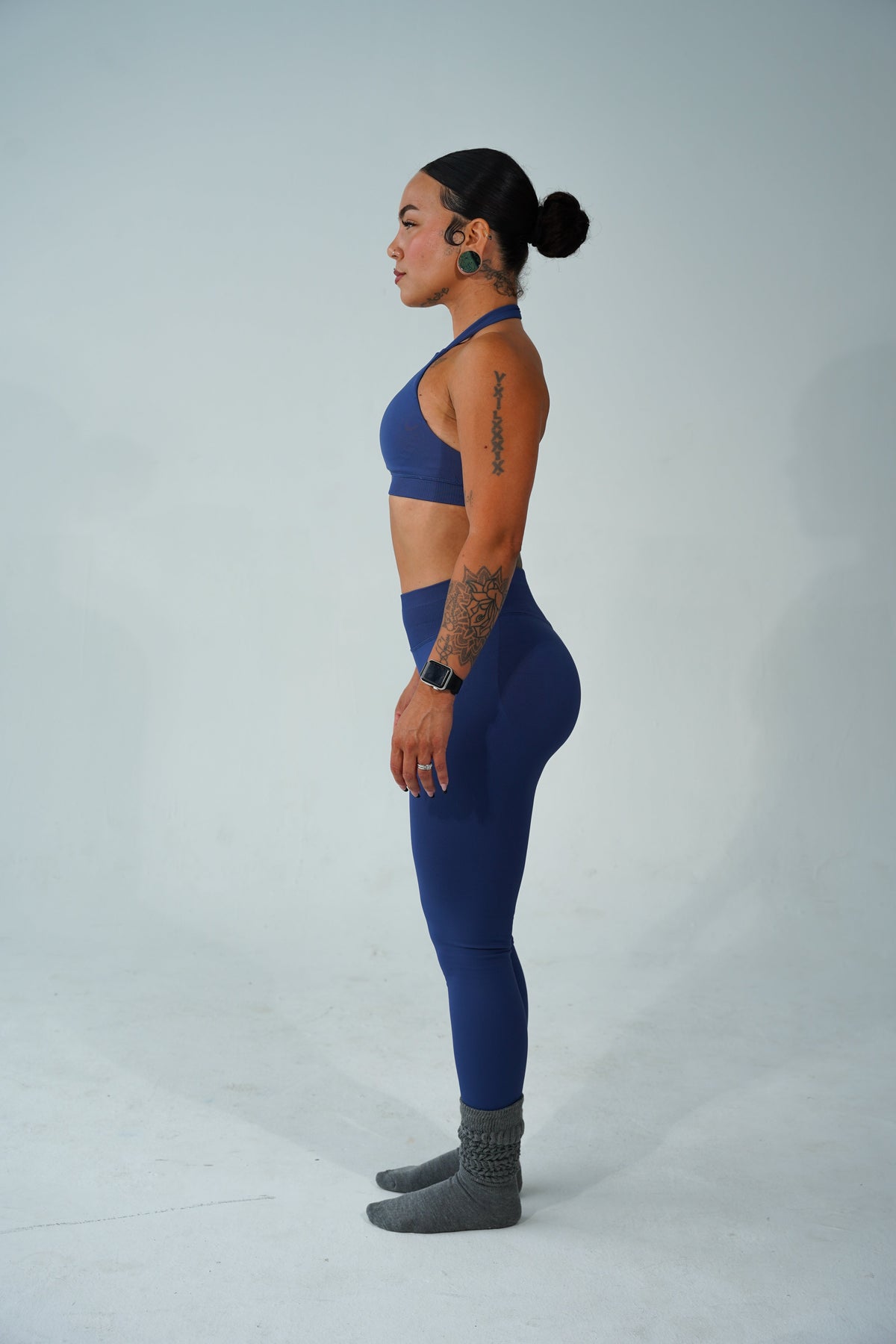 Woman standing tall and confident after realizing the full body workout benefits for her posture and energy.