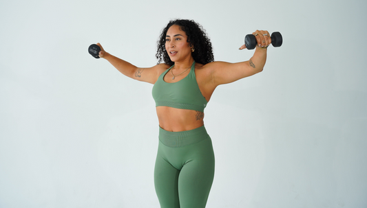 Woman performing a shoulder press as part of an upper body workout for women to build definition.