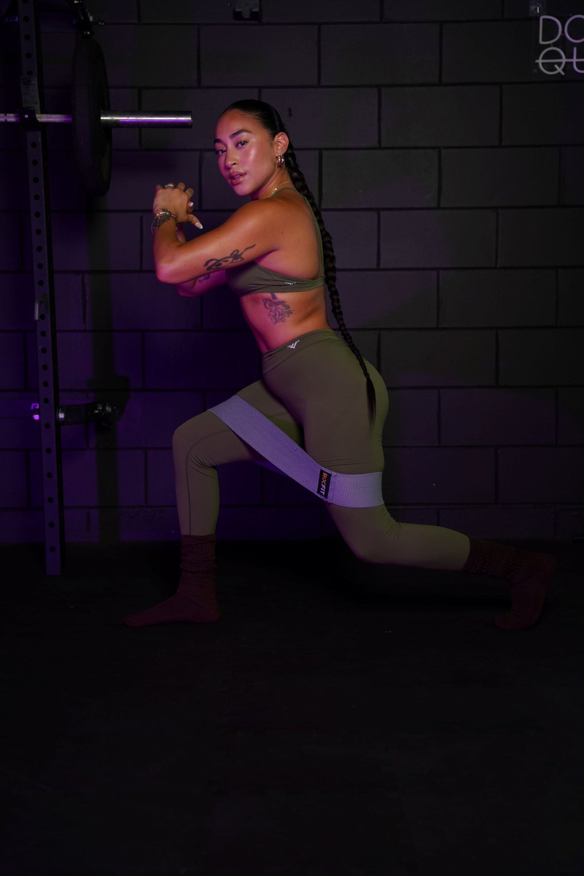 Woman performing a resistance band glute workout for hip stability and muscle growth.