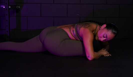 Woman deciding between a full body workout vs split routine in a home gym setting.