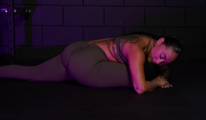 Woman deciding between a full body workout vs split routine in a home gym setting.